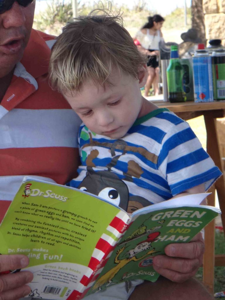 https://www.writteninwaikiki.com/11-ways-to-encourage-your-child-to-love-reading/ child toddler reading read book