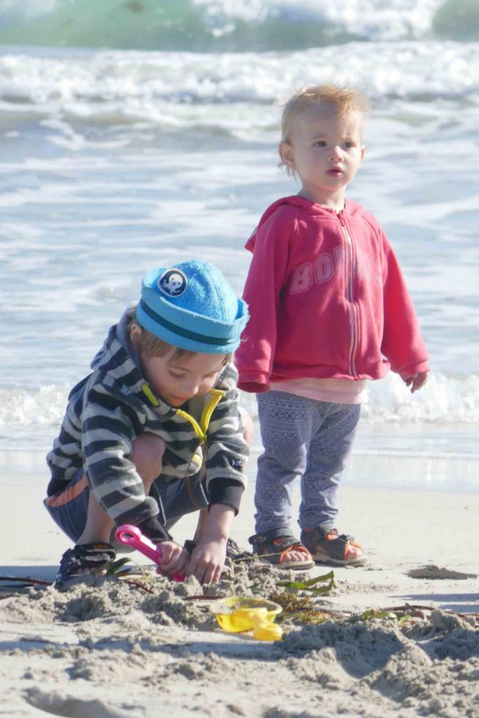 https://www.writteninwaikiki.com/why-i-started-this-blog/ kids siblings playing in sand at the beach Waikiki Rockingham Western Australia