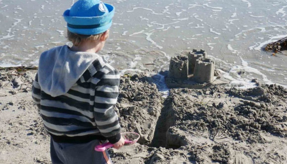 https://www.writteninwaikiki.com/why-i-started-this-blog/ kids playing in sand at the beach Waikiki Rockingham Western Australia