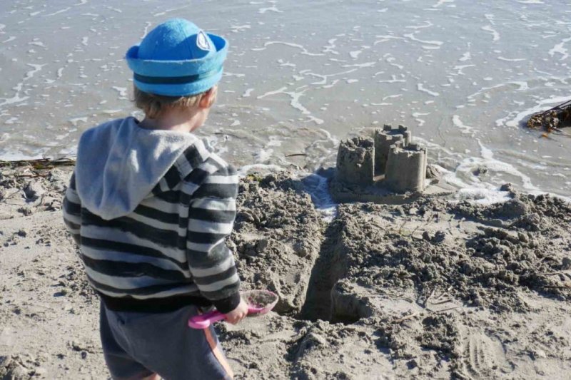 https://www.writteninwaikiki.com/why-i-started-this-blog/ kids playing in sand at the beach Waikiki Rockingham Western Australia