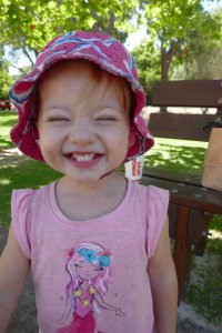 girl toddler with a cheeky smile