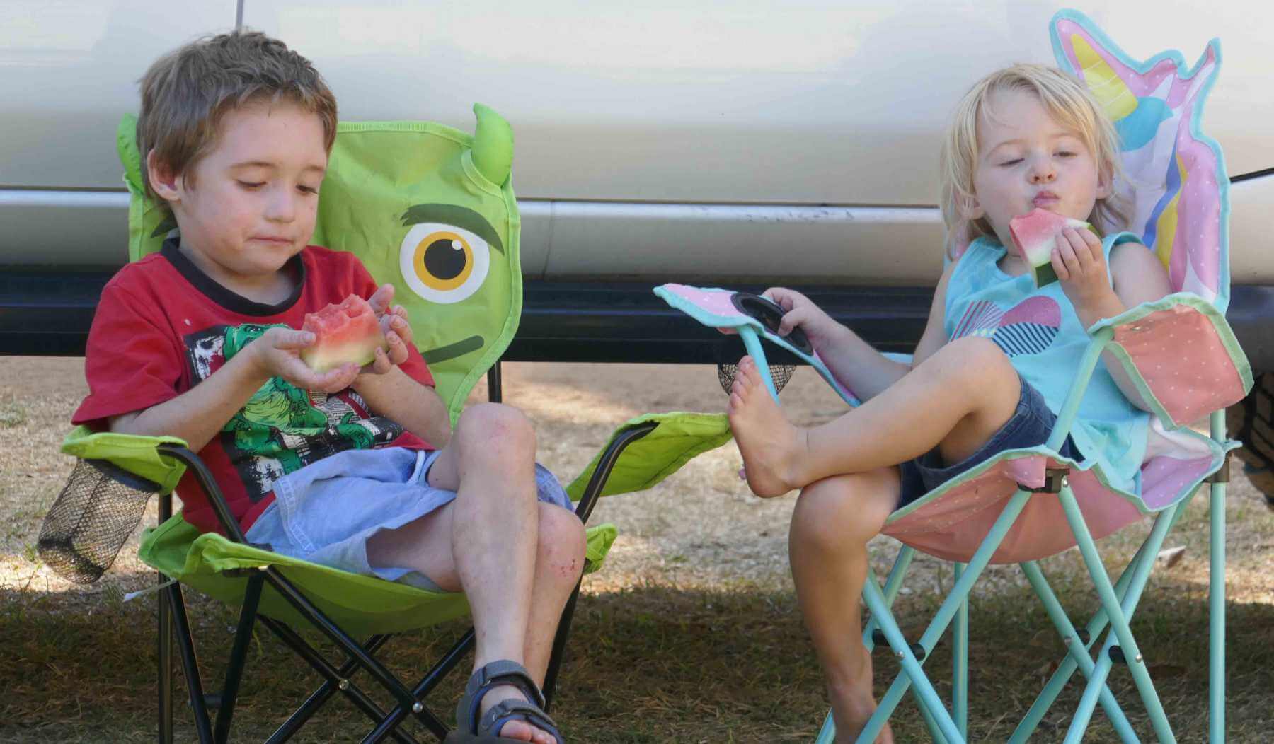 kids sitting on camp chairs on a camping trip