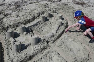 Boy building sandcastles at the beach