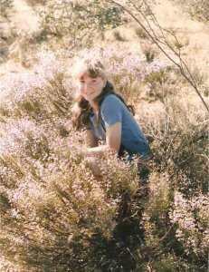 girl sitting in wildflowers