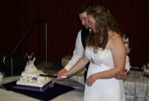 married couple cutting cake