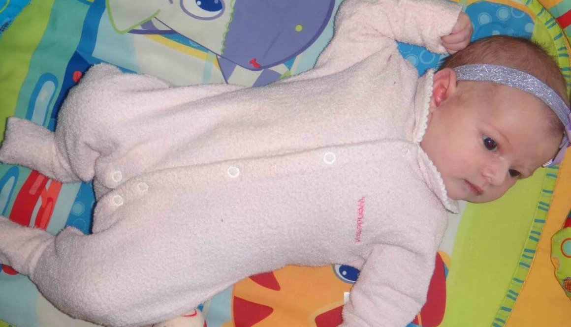 baby lying on play mat