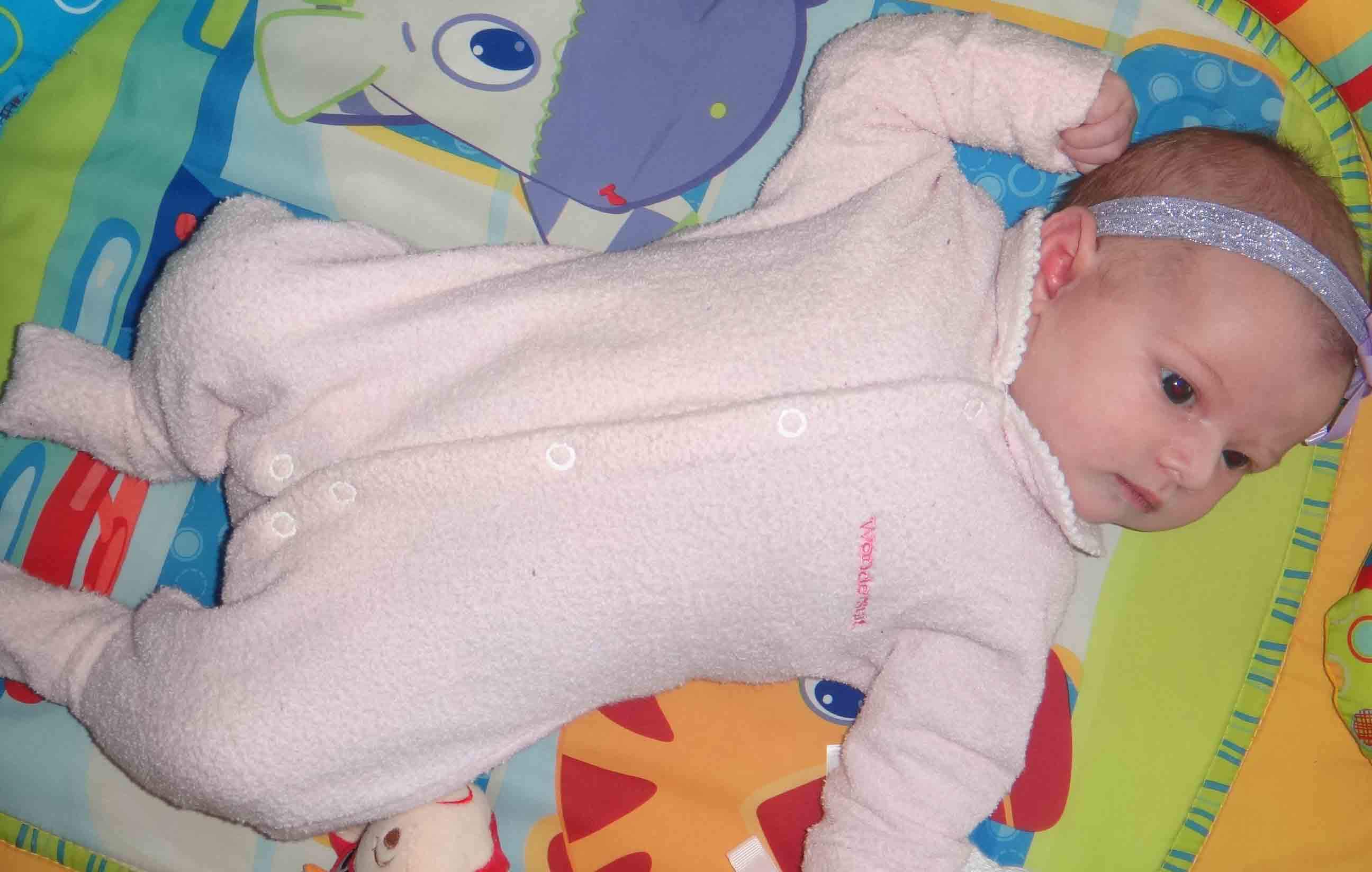 baby lying on play mat