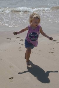 girl running at beach feeling free