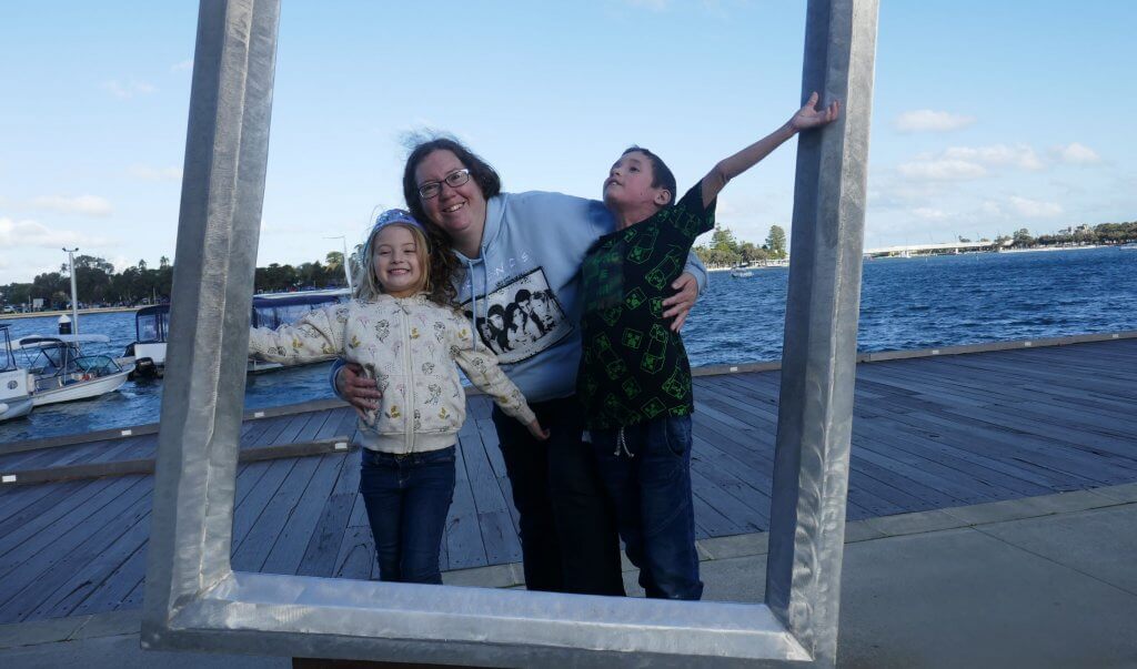 mum and kids out having fun by the water