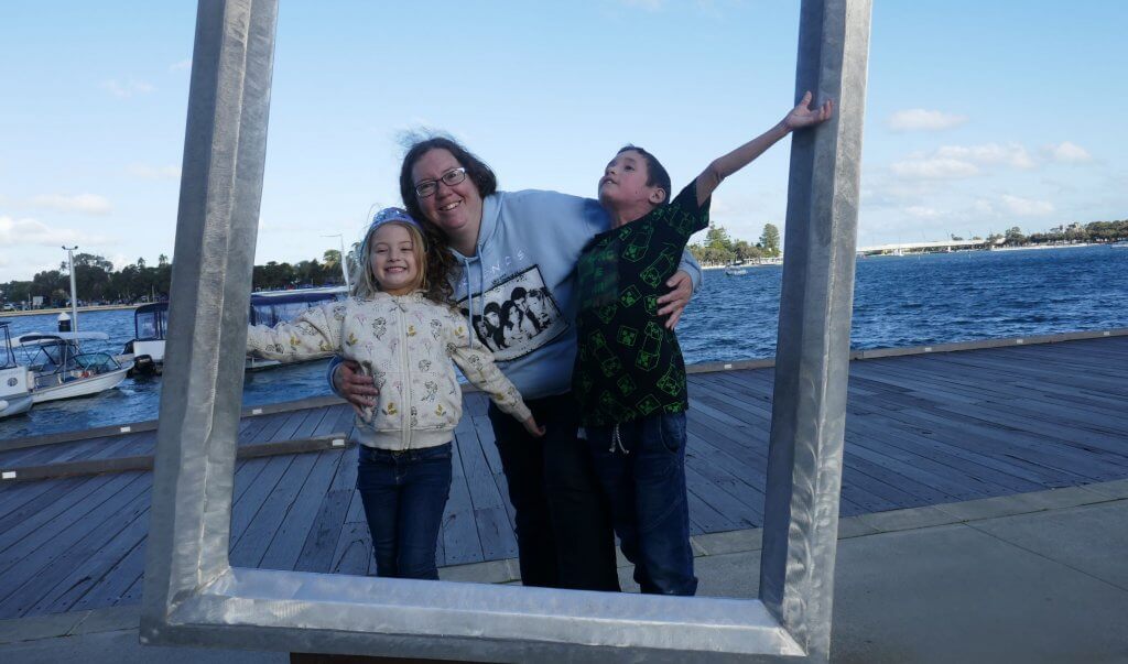 mum and kids out having fun by the water